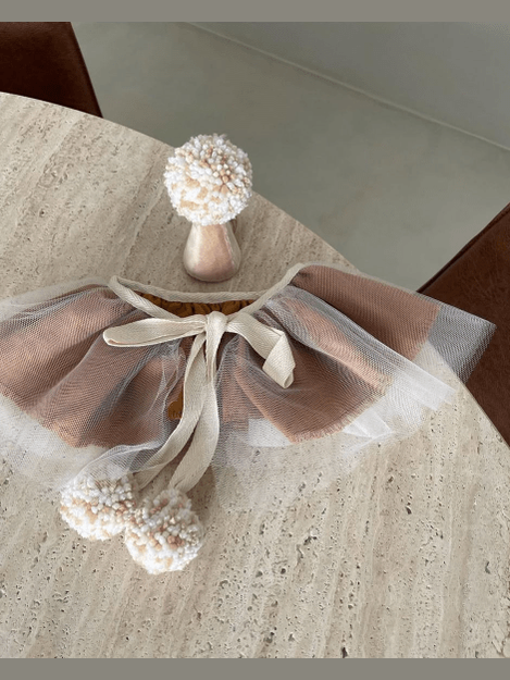 Beige cape and a birthday hat